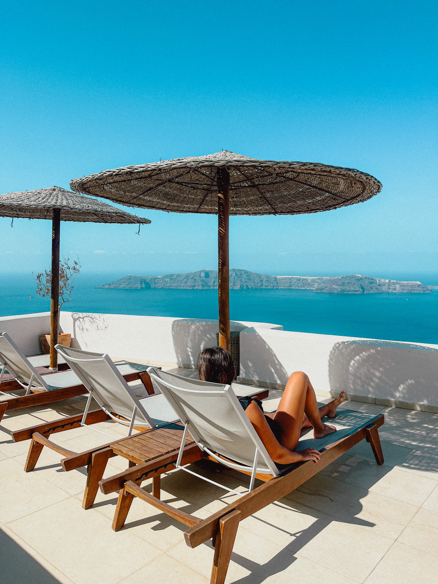 Relaxing at a luxury resort in Santorini, booked with points